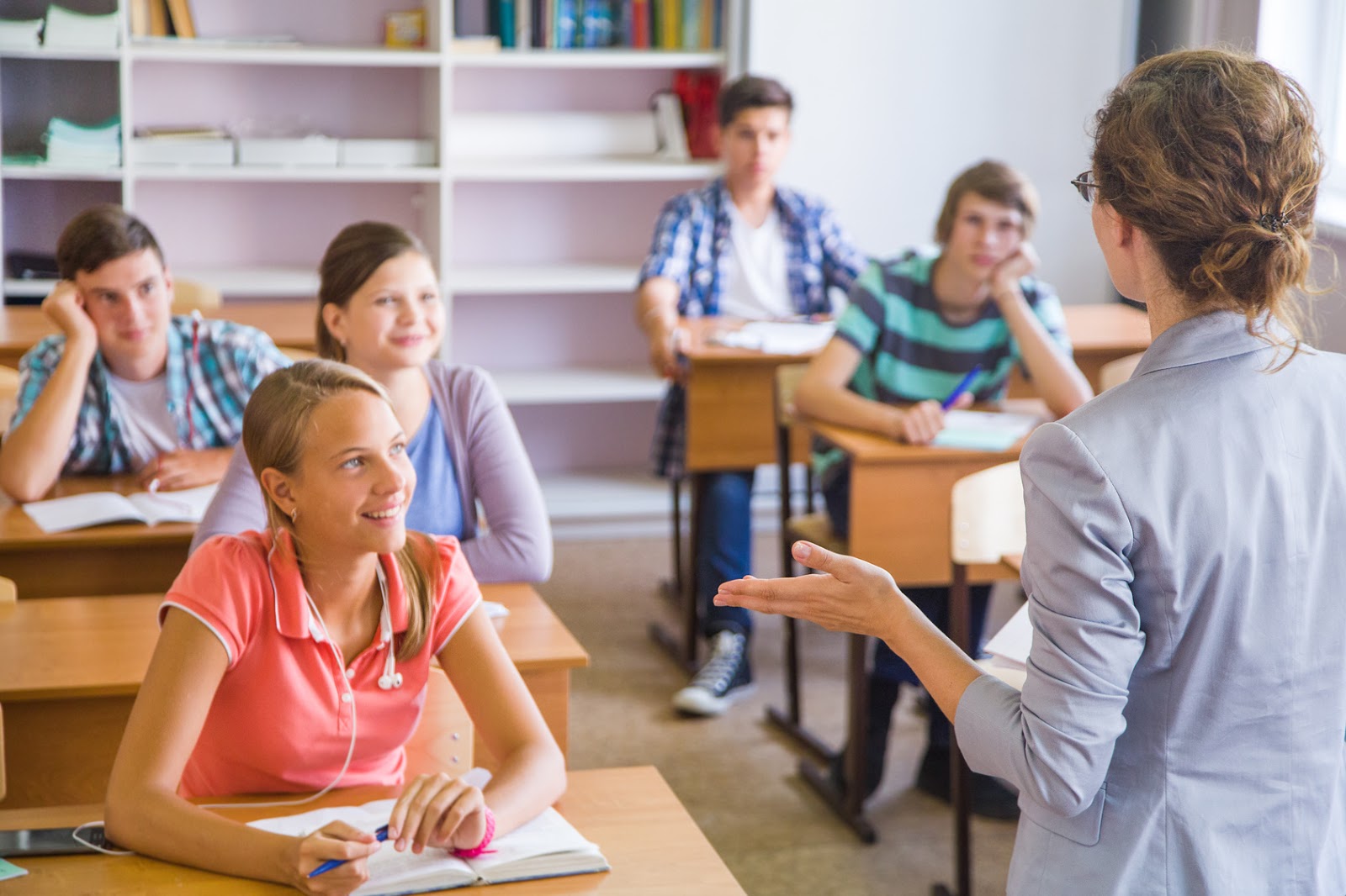 group of students listening to the teacher in the classroom at school -  Resources for English Language Learners and Teachers | Pearson English