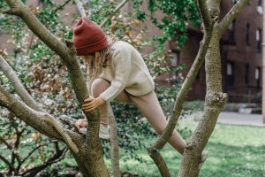 young girl climbing in tree